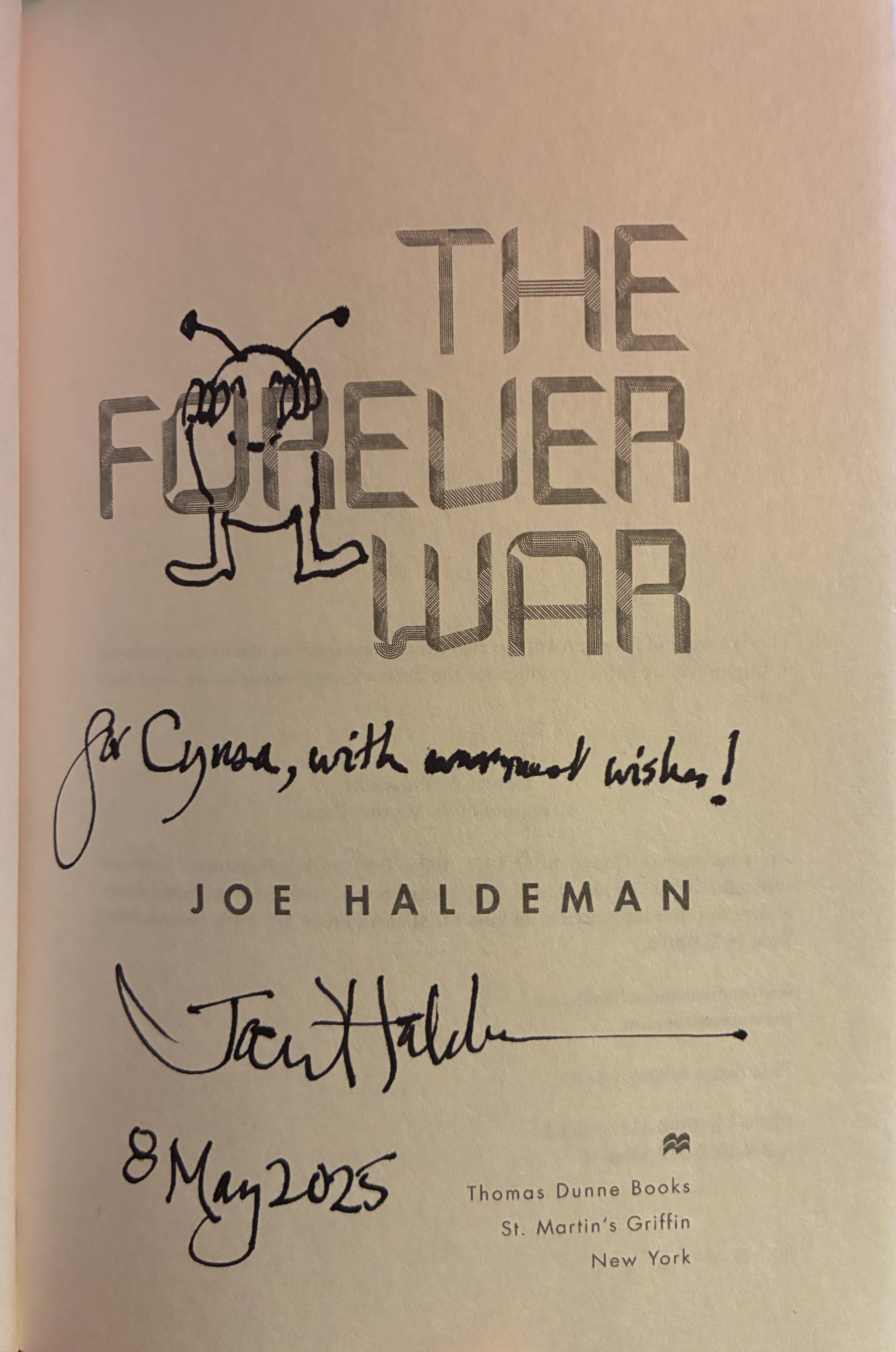 The title page of The Forever War by Joe Haldeman, signed by Joe with an inscription and a cute drawing of an alien hanging off the title.