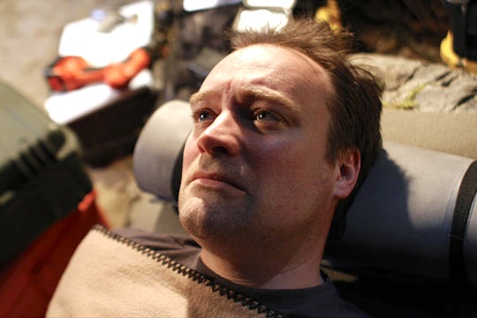 Rodney McKay lying on his back staring up. He looks quite handsome, if worried. 
